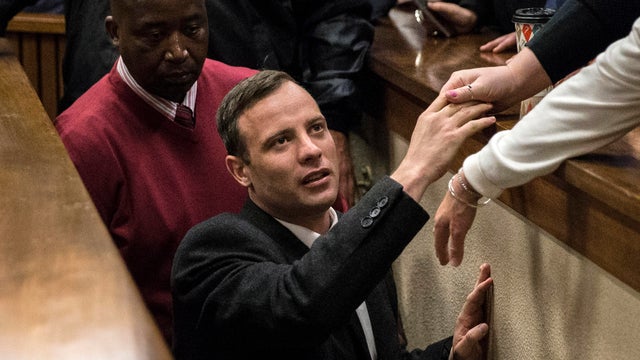 Olympic athlete Oscar Pistorius holds the hand of a relative after sentencing on July 6, 2016, at the High Court in Pretoria, South Africa. 