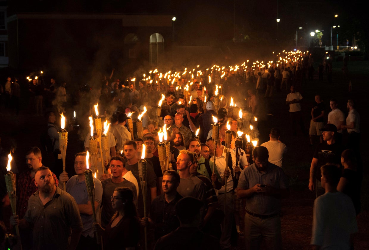 White nationalists carry torches on the grounds of the University of Virginia, on the eve of a planned "Unite The Right" rally in Charlottesville, Virginia, Aug. 11, 2017.