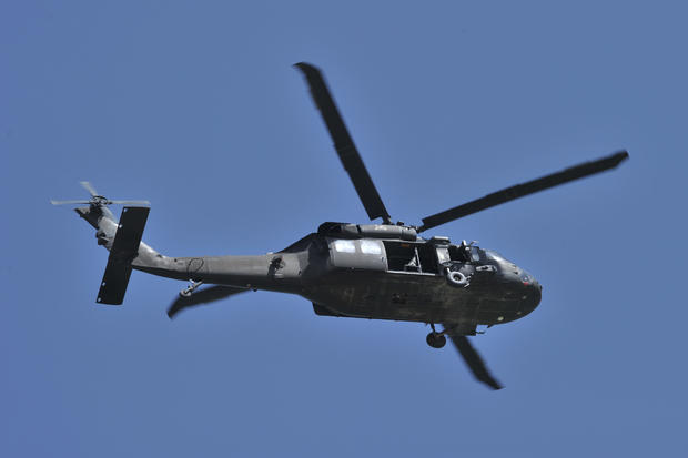 A UH-60 Black Hawk helicopter flies near 