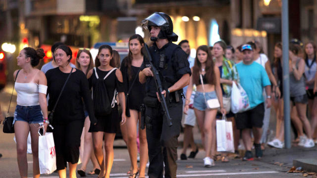 Police evacuate people after a van crashed into pedestrians near the Las Ramblas avenue in central Barcelona, Spain, Aug. 17, 2017. 