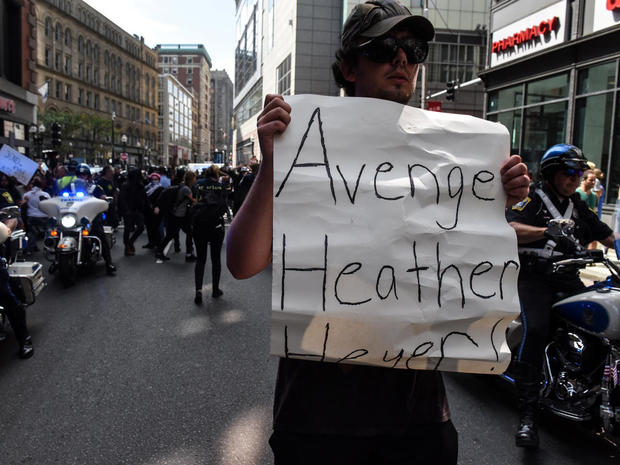 A counter protester holds a sign during clashes with Boston Police outside of the Boston Commons and the Boston Free Speech Rally in Boston, Massachusetts 
