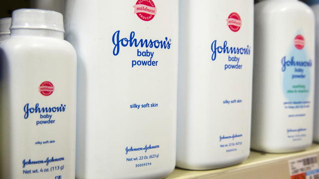 Bottles of Johnson & Johnson baby powder line a drugstore shelf in New York 