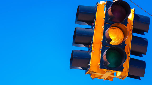 Yellow traffic light with a sky blue background 