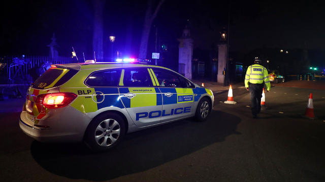 A police officer stands at a cordon after police arrested a man carrying a knife outside Buckingham Palace in London 