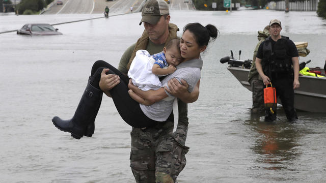 A vehicle sits half submerged in flood waters in a residential area in the aftermath of Hurricane Harvey in Houston 