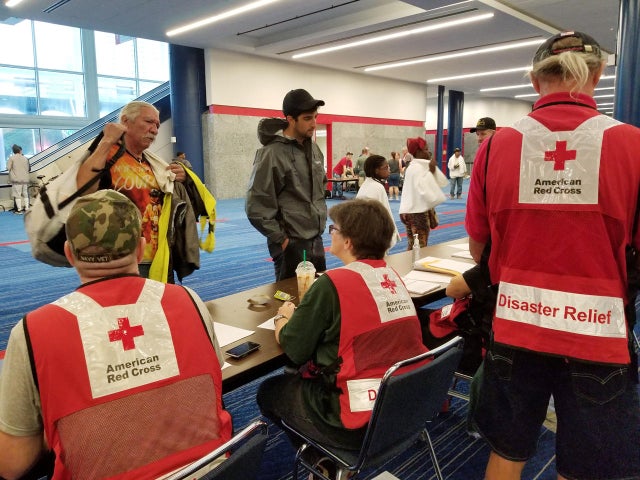 Evacuees arrive to seek shelter with Red Cross volunteers at the George Brown convention center after flood waters of Hurricane Harvey forced them to leave their homes in Houston 