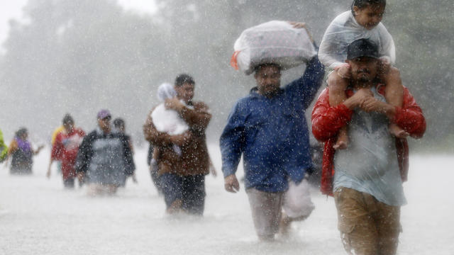 Residents wade through flood waters from Tropical Storm Harvey in Beaumont Place, Houston 