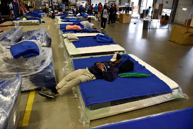 Evacuees get some rest in the warehouse at Gallery Furniture in Houston 