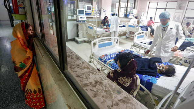 Woman looks into the ICU at the Baba Raghav Das hospital in Gorakhpur district 