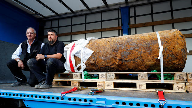 Bomb disposal expert Rene Bennert and Dieter Schweizler speak next to defused massive World War Two bomb after tens of thousands of people evacuated their homes in Frankfurt 