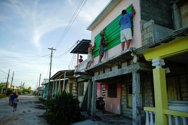 People protect the windows of a house prior to the arrival of the Hurricane Irma in Caibarien