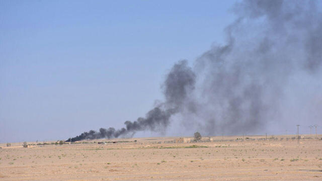 Smoke rises in Deir al Zor in this handout picture provided by SANA 