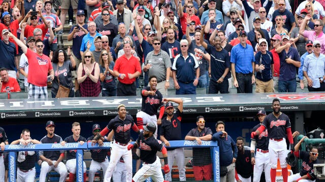 The Cleveland Indians celebrate as first baseman Carlos Santana (41) rounds third base on an attempted inside-the-park home run in the eighth inning against the Detroit Tigers at Progressive Field in Cleveland on Sept. 13, 2017. Santana was tagged out at  