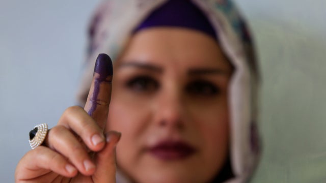 A woman shows her ink-stained finger during Kurds independence referendum in Halabja 