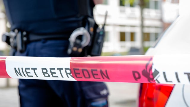 Dutch policeman behind plastic tape 