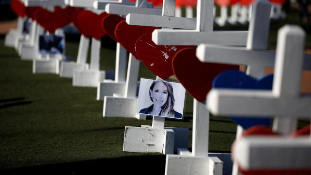 A photograph hangs from one of the 58 white crosses set up for the victims of the Route 91 Harvest music festival mass shooting in Las Vegas, Nevada, Oct. 5, 2017. 
