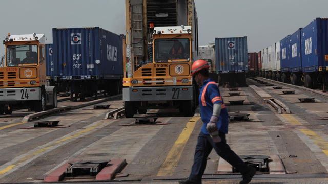 Workers unload containers of shipping company Crowley from a barge after the area was hit by Hurricane Maria at the port in San Juan 