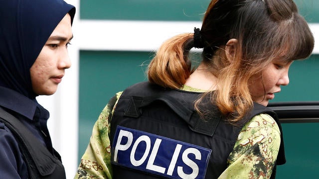 Vietnamese Doan Thi Huong who is on trial for the killing of Kim Jong Nam, the estranged half-brother of North Korea's leader, is escorted as she leaves at the Department of Chemistry in Petaling Jaya, 