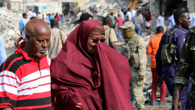 Somali government forces and civilians gather at the scene of an explosion in KM4 street in the Hodan district of Mogadishu 