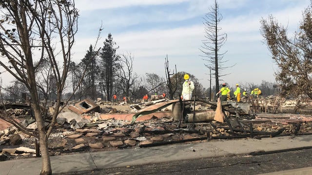 Search-and-rescue teams comb through the Coffey Park area looking for dozens of people still missing in the state's deadliest wildfires, in Santa Rosa, California 