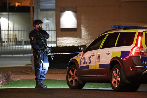 A police officer guards outside a cordoned area surrounding the police station in Helsingborg 