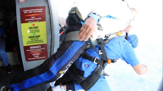 Rich Gately and his skydiving instructor jump out of an airplane over Massachusetts on Oct. 28, 2017, in this photo provided to CBS station WBZ-TV. 