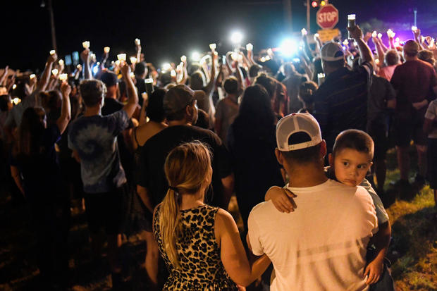 Local residents embrace during a candlelight vigil for victims of a mass shooting in a church in Sutherland Springs, Texas 