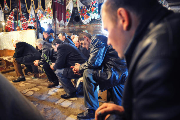 Romanian believers pray during the Palm 