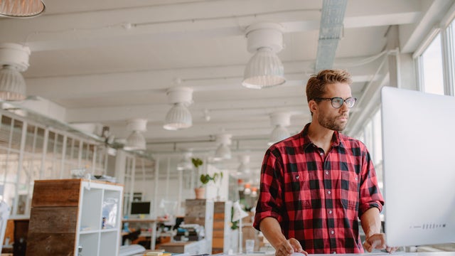 Young man working on computer in modern workplace 