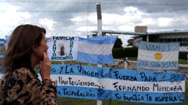 A woman looks at signs in support of the missing crew members of the ARA San Juan submarine in Mar del Plata 