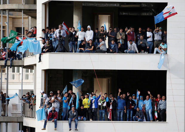 Supporters of Saad al-Hariri who suspended his decision to resign as prime minister are seen near his home in Beirut 