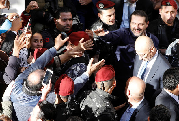 Saad al-Hariri, who suspended his decision to resign as prime minister, gestures to his supporters at his home in Beirut 
