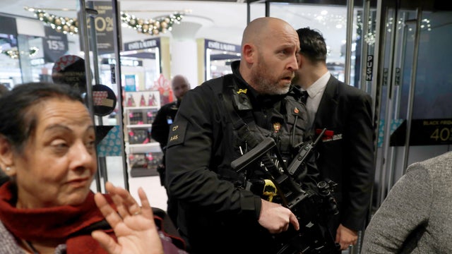 Armed police officers mix with shoppers in an Oxford Street store in London, Britain, Nov. 24, 2017. 