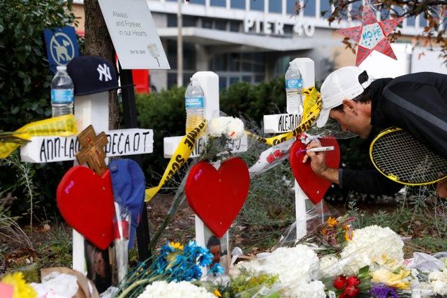 A man leaves a note on a memorial left along a bike path to remember the victims of the Oct. 31, 2017, New York terror attack, in New York City Nov. 3, 2017. 