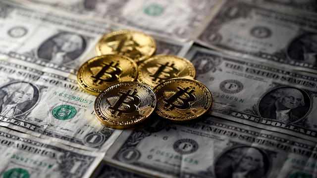 FILE PHOTO: Bitcoin (virtual currency) coins placed on Dollar banknotes are seen in this illustration picture 