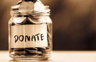 Close up Coins in glass jar for giving and donation 