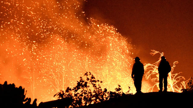 Firefighters keep watch on the Thomas wildfire in the hills and canyons outside Montecito, California 