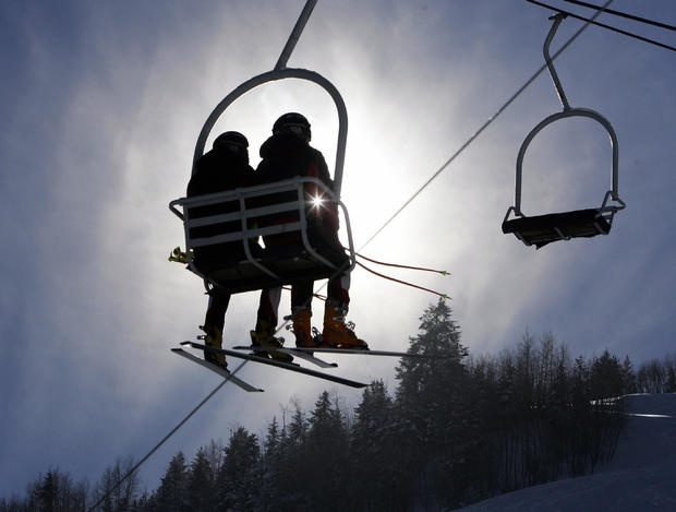 Ski racers take a chair lift up the hill 