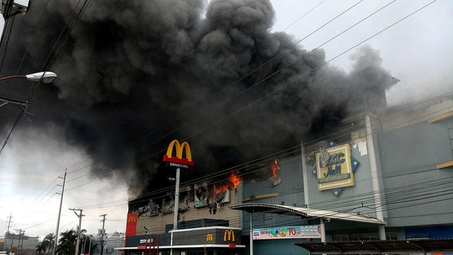 Smoke billows from a shopping mall on fire in Davao City 