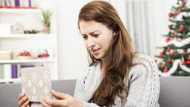 young girl is unhappy about her christmas gift 