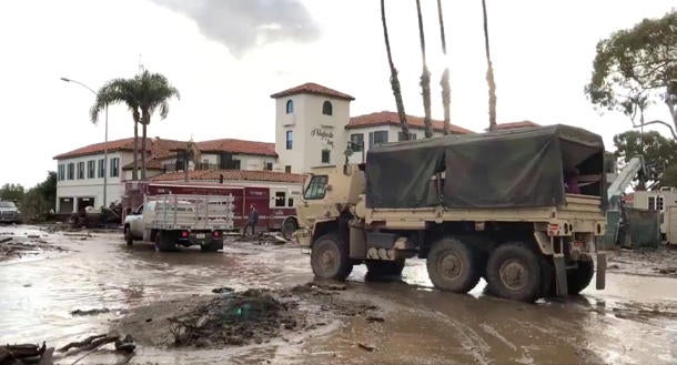 Military vehicles arrive to assist evacuation operations at an area damaged by mudslides in Montecito, California, U.S.