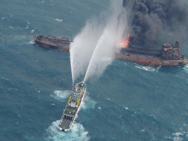 A rescue ship works to extinguish the fire on the stricken Iranian oil tanker Sanchi in the East China Sea 