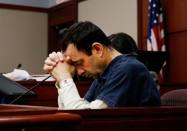 Larry Nassar listens to a victim during his sentencing hearing in Lansing 