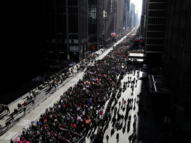 People walk down Sixth Avenue as they participate in the Women's March in Manhattan, New York 