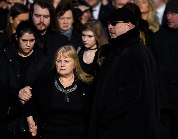 Eillen O'Riordan leaves her daughter Dolores O'Riordan's funeral with Dolores' ex-husband Don Burton and one of their daughters at St Ailbe's Church in Ballybricken 