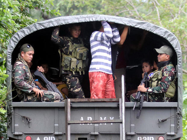 Soldiers and residents are seen on a military truck departing to evacuation centers after Mayon volcano erupted anew, in Padang town 