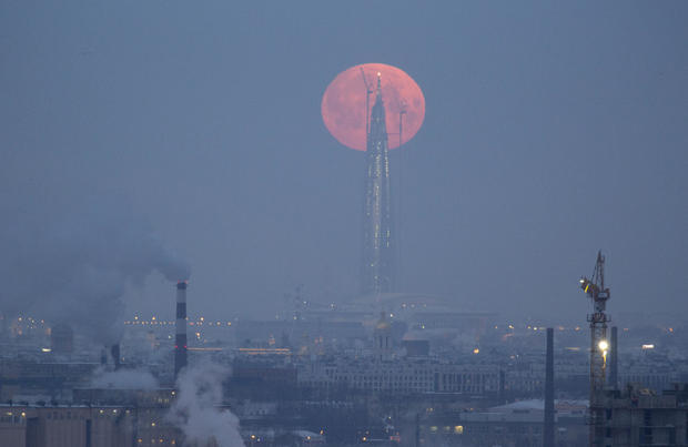 A full moon is seen behind the business tower Lakhta Centre in St. Petersburg 