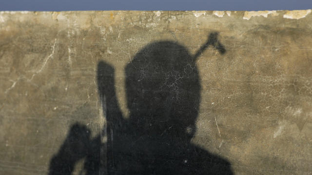 Turkey-backed Free Syrian Army fighter's shadow is seen on a wall in the eastern suburbs of al-Bab 