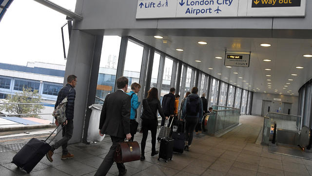 FILE PHOTO: Passengers alight from a train to enter City Airport in London, Britain 