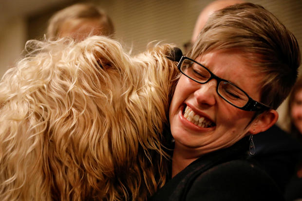 An Otterhound named Willie Nelson licks a guest backstage before judging at The 142nd Westminster Kennel Club Dog Show in New York 